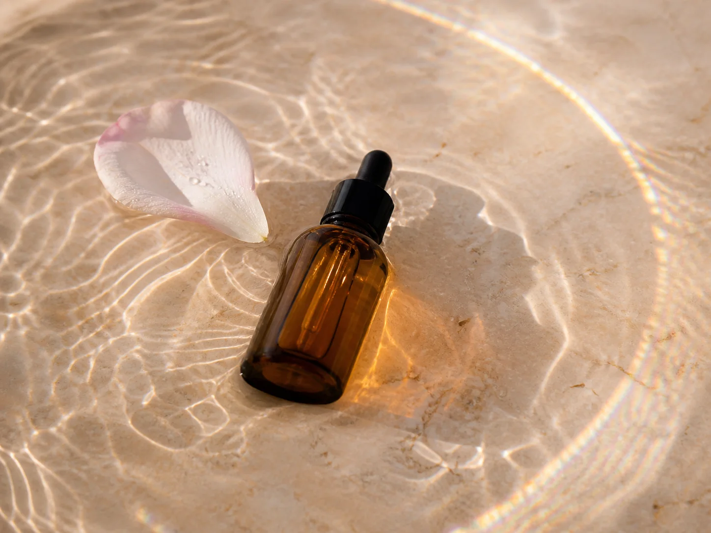 Amber botanical serum bottle standing in shallow water generated by Video Studio AI