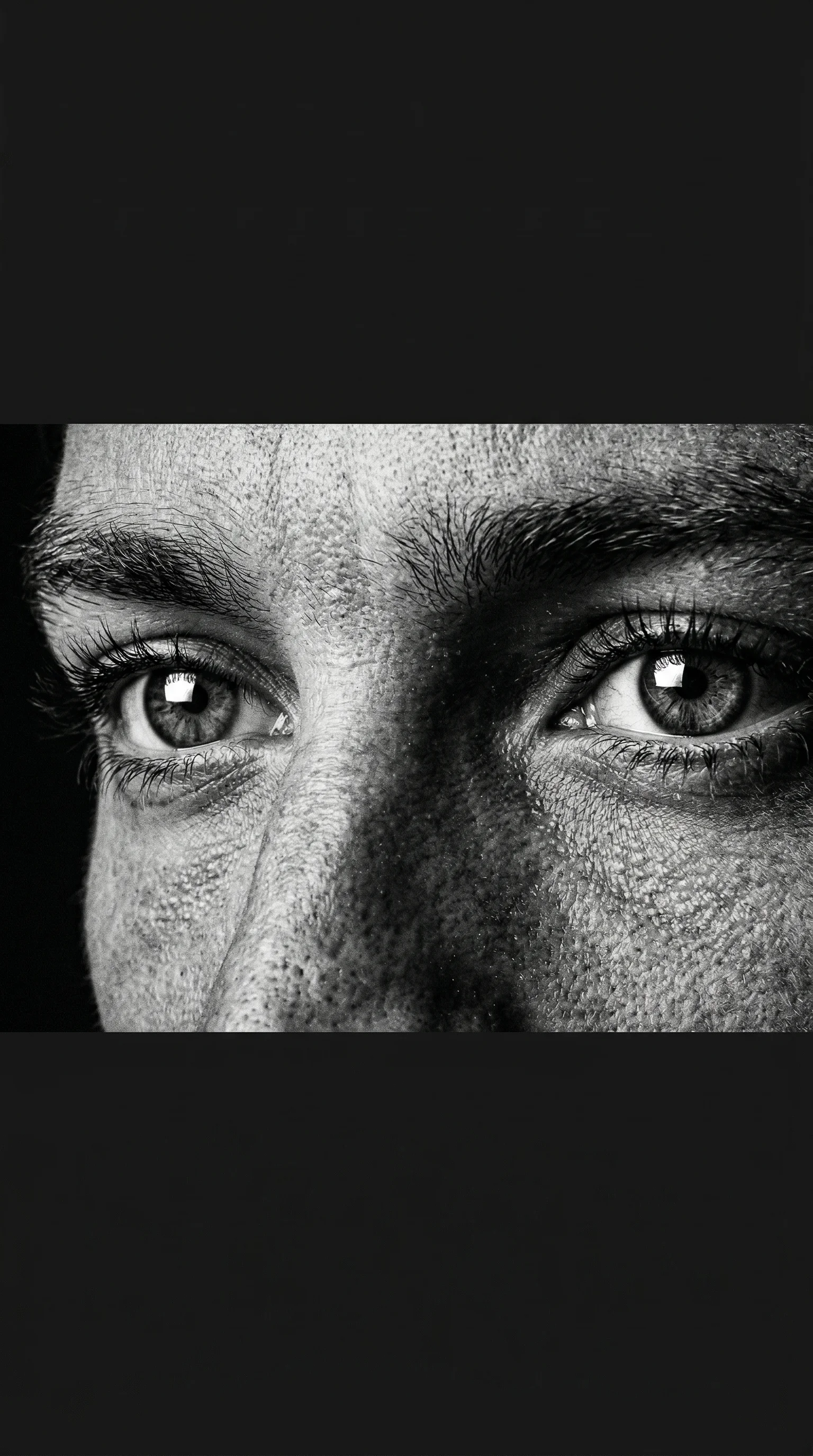 Extreme close-up of eyes and nose bridge with hyper-detailed skin texture — black and white portrait prompt for Video Studio AI